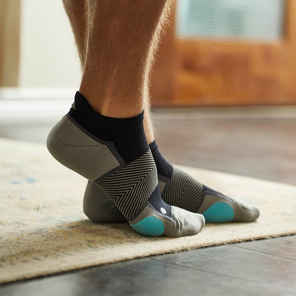 Feet with compression socks to help arch support and support fitted therapeutic footwear