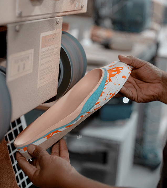 A person customizing a shoe insert for men and women with foot conditions to wear walking or running orthotic shoes for services offered.