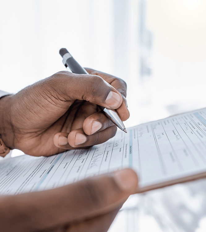 Person filling out forms for approval process for insurance and medical providers for services offered.